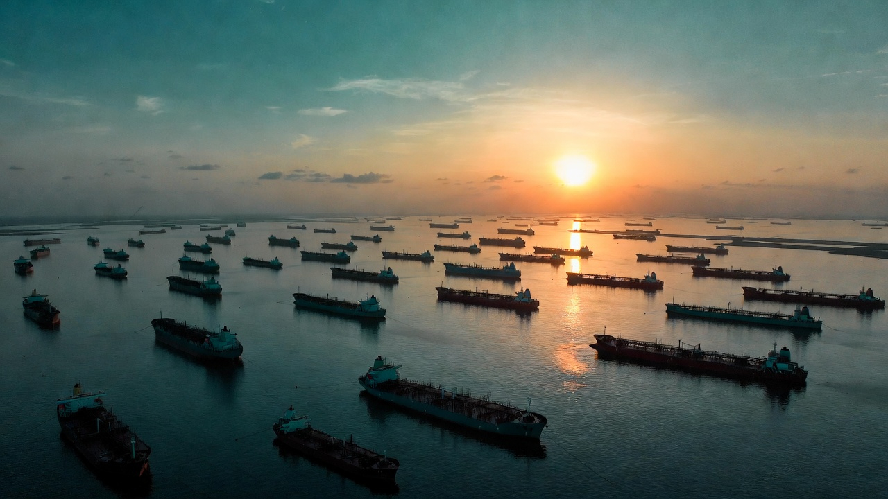 Aerial shot — Strait of Hormuz frozen tanker fleet at sunset