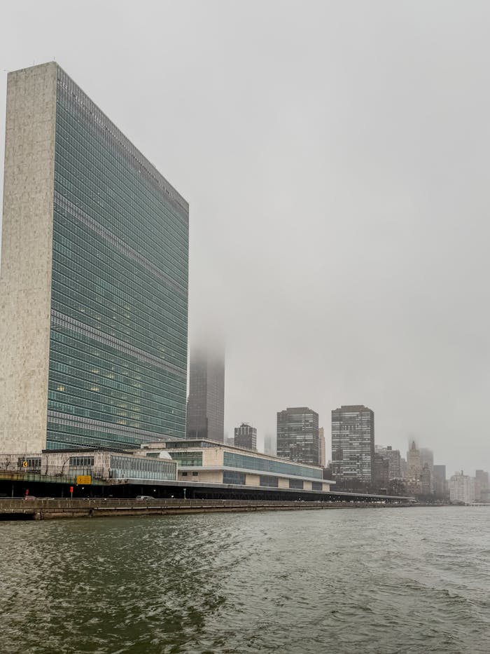 Misty view of the United Nations Headquarters and New York City skyline from the East River.