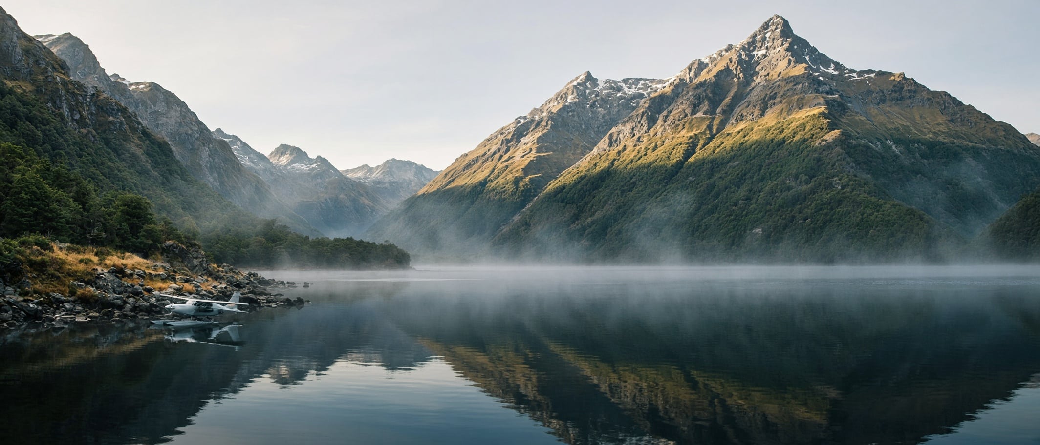 Heart of the Beast Illustration: a small floatplane moored on a still mountain lake